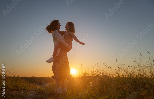 Happy family at sunset