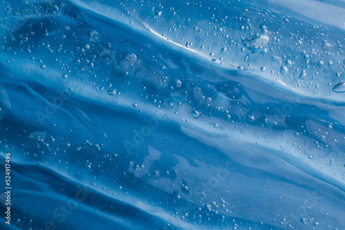 Texture of light blue shower gel as background, top view