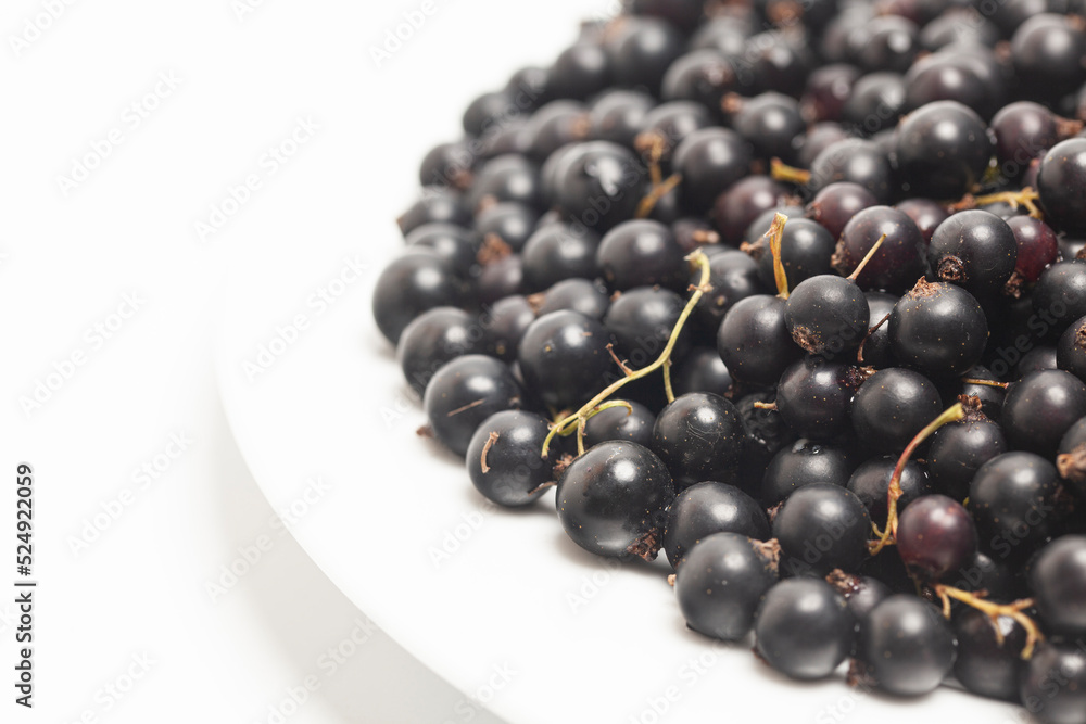 Black currants on a plate top view