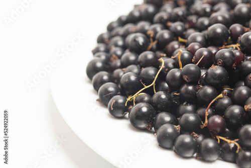 Black currants on a plate top view