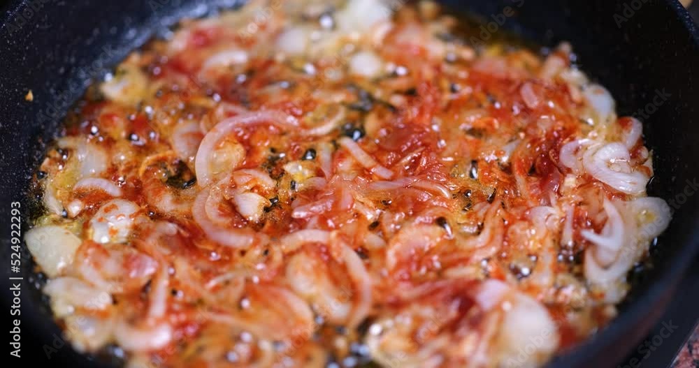 Chopped white onion is fried in a pan in boiling oil Chopped white onion is fried in a pan in boiling oil