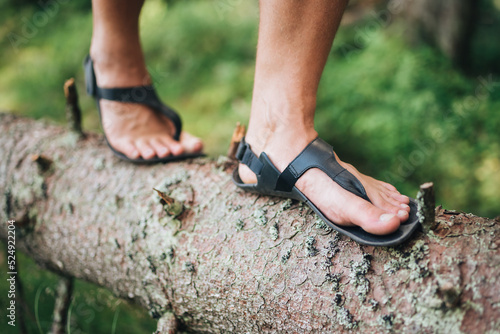 Obraz na płótnie Man walking in barefoot shoes in the forest