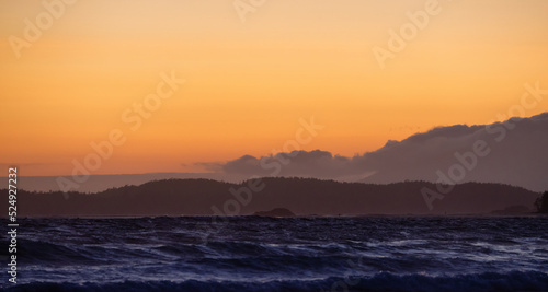 Waves on the Pacific Ocean on a rocky beach. West Coast. Sunny Summer Sunset. Cox Bay, Tofino, Vancouver Island, BC, Canada. Canadian Nature Background.