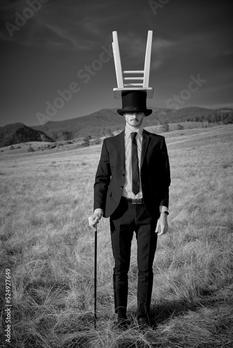 man with stool on head