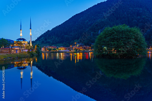 Uzungol Mosque and its reflection in water at the twilight in the mountain town of Uzungol photo