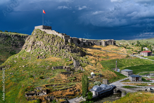 View over the Kars Castle with dark clouds in the sky in the province of Kars, Turkey photo