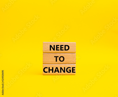 Need to change symbol. Concept words 'Need to change' on wooden blocks. Beautiful yellow background. Business and Need to change concept. Copy space.