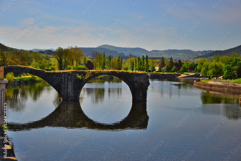 Brives-Charensac, France - May 5th 2019 : View of Le vieux pont (the old bridge), built in the 13th century. The river is la Loire, it's the biggest river which flows entirely in France.