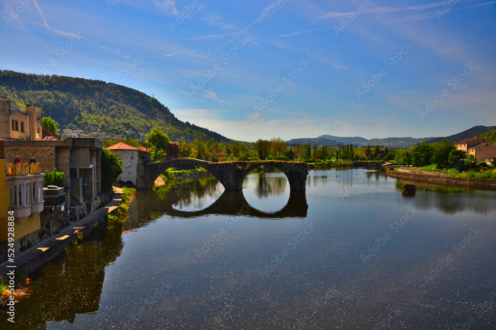 Brives-Charensac, France - May 5th 2019 : View of Le vieux pont (the old bridge), built in the 13th century. The river is la Loire, it's the biggest river which flows entirely in France.