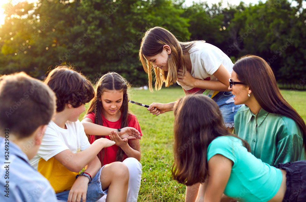 Group of kids playing games and having fun in nature. Joyful little children dancing a round dance on green grass in the park. Several happy little friends holding hands and running in a circle Group of kids playing games and having fun in nature. Joyful little children dancing a round dance on green grass in the park. Several happy little friends holding hands and running in a circle