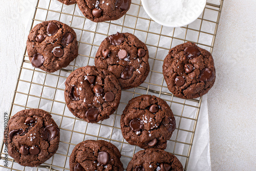 Double chocolate cookies with dark chocolate chips and salt flakes photo