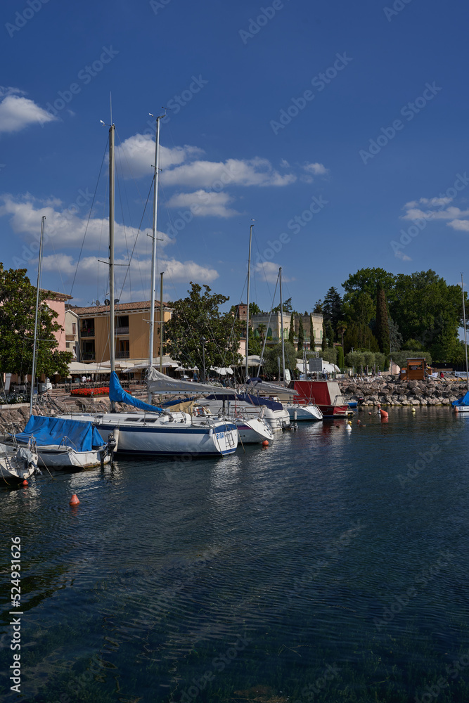 Bardolino, Italy - July 11, 2022 - Cisano - the small boat harbor on a summer afternoon       