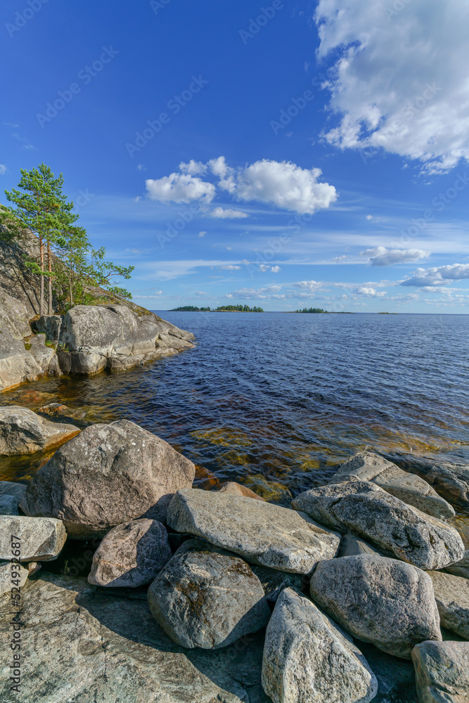 Beautiful stones and pine trees on the lake. Landscape of wild nature.