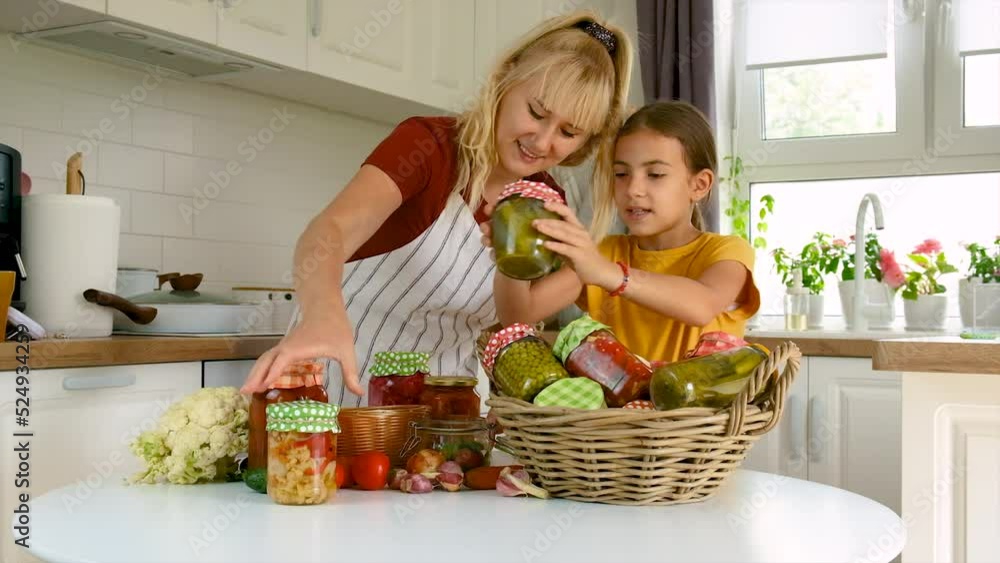 Woman with jar preserved vegetables for winter mother and daughter. Woman with jar preserved vegetables for winter mother and daughter.