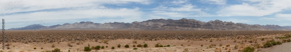 American Mountain Landscape in the desert. Sunny Cloudy Sky. Nevada, United States of America. Nature Background Panorama American Mountain Landscape in the desert. Sunny Cloudy Sky. Nevada, United States of America. Nature Background Panorama