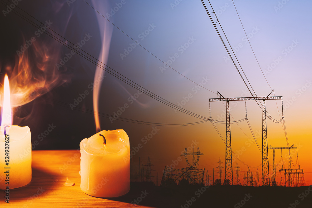 Burning flame and extinguished candle and power lines on background