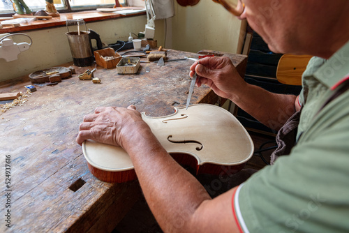Obraz na plátně luthier carving and sculpting the f holes a violin with a knife