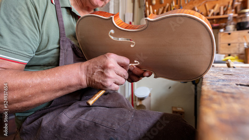 Obraz na plátně luthier carving and sculpting the f holes a violin with a knife