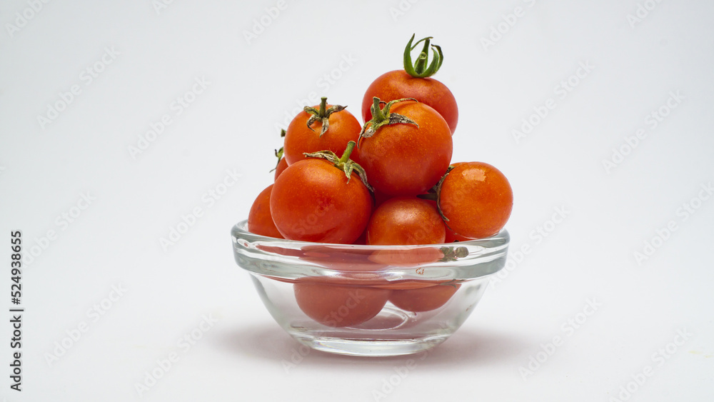 red cherry tomatoes in a glass bowl on a white background red cherry tomatoes in a glass bowl on a white background