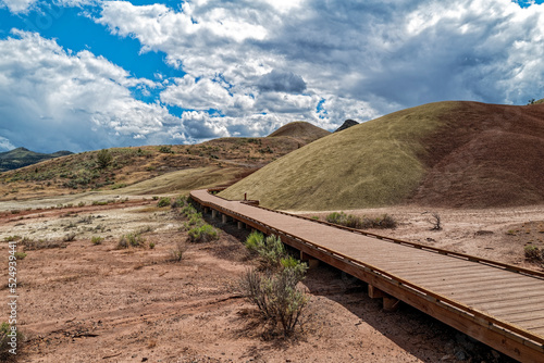 Boardwalk trail through the claystone hills at the Painted Hills Unit of the John Day Fossil Beds National Monument, Oregon, USA photo