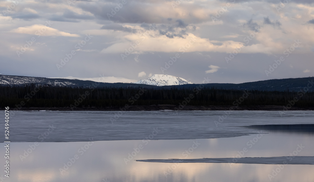 View of a frozen Yellowstone Lake with snow covered mountains in American Landscape. Yellowstone National Park. United States. Nature Background.