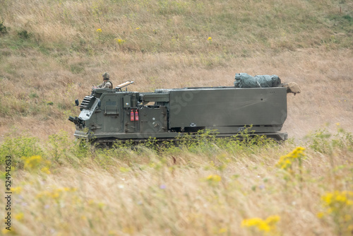 British army self propelled M270 Multiple Launch Rocket System (MLRS) in action on a military exercise photo