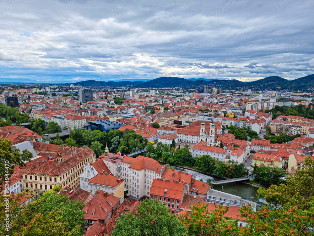 Obraz premium Beautiful view over the old city center of Graz, with Mariahilfer church and historic buildings, in Styria region, Austria