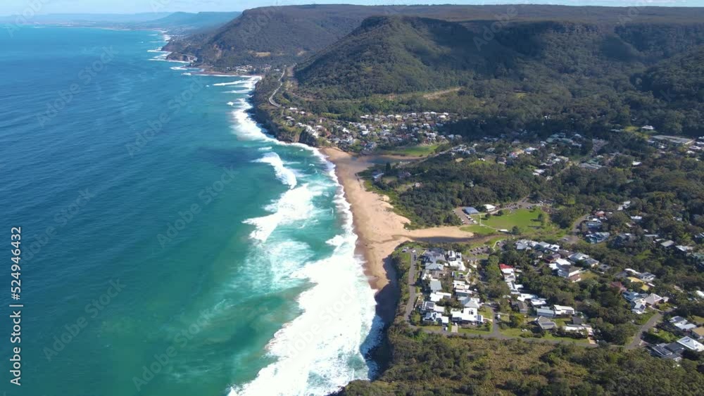 Aerial drone pullback reverse view of the coast of Stanwell Tops between Sydney and Wollongong on the New South Wales, Australia coastline, looking toward Bald Hill Lookout and Stanwell Park Beach Aerial drone pullback reverse view of the coast of Stanwell Tops between Sydney and Wollongong on the New South Wales, Australia coastline, looking toward Bald Hill Lookout and Stanwell Park Beach