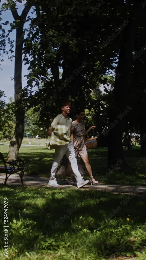 a couple meeting and walking through the park together a couple meeting and walking through the park together
