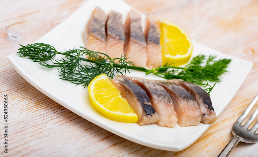 Marinated herring fillet with sliced lemon and dill, healthy food