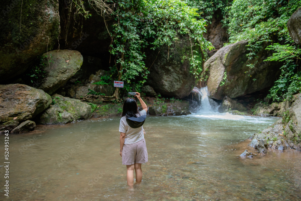 Fototapeta premium A vacation to a waterfall in the middle of the forest in the high valley.