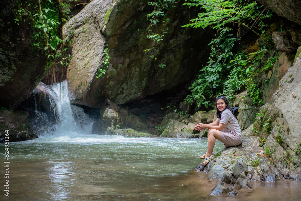 Fototapeta premium A vacation to a waterfall in the middle of the forest in the high valley.