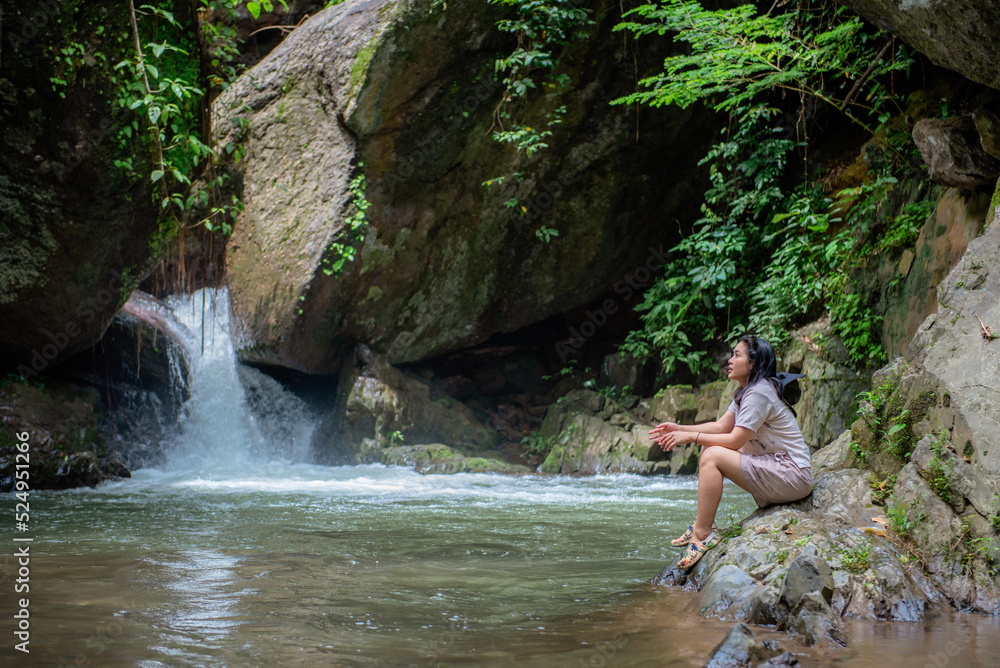 Fototapeta premium A vacation to a waterfall in the middle of the forest in the high valley.