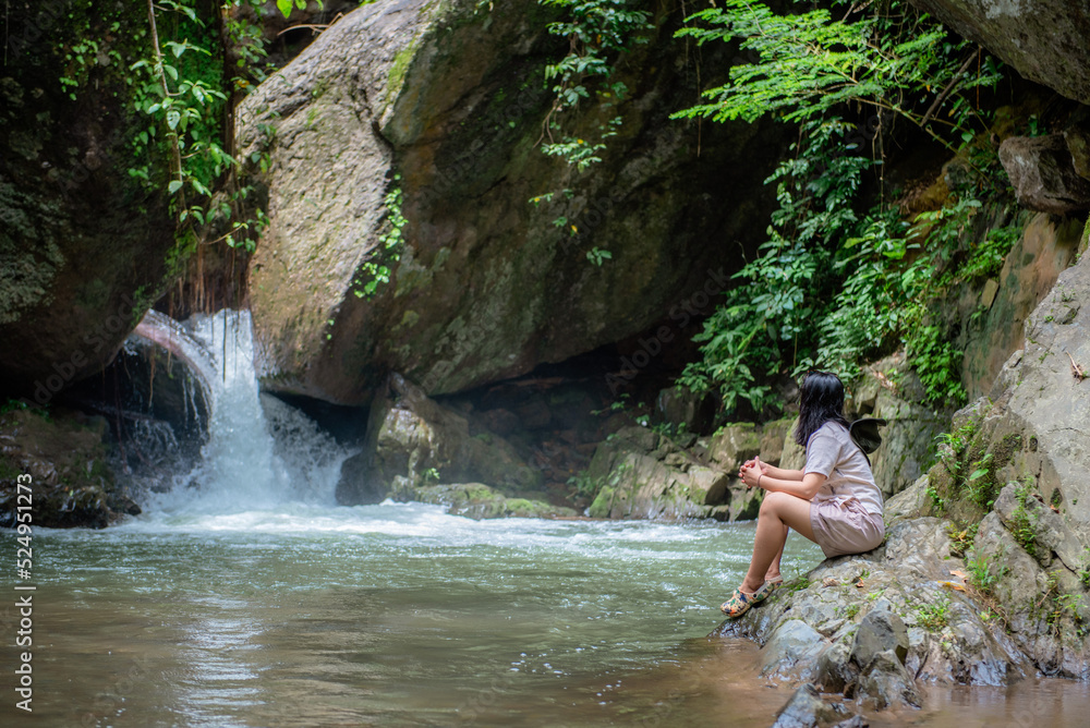 A vacation to a waterfall in the middle of the forest in the high valley.