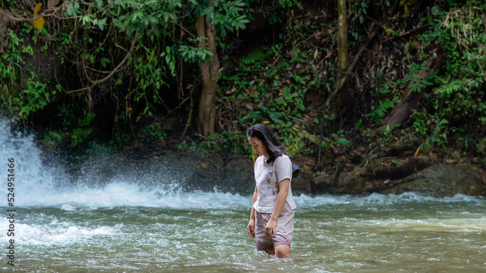 Fototapeta premium A vacation to a waterfall in the middle of the forest in the high valley.
