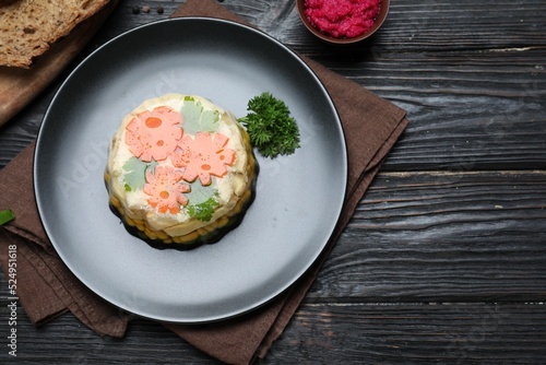 Delicious homemade chicken aspic served on black wooden table, flat lay photo