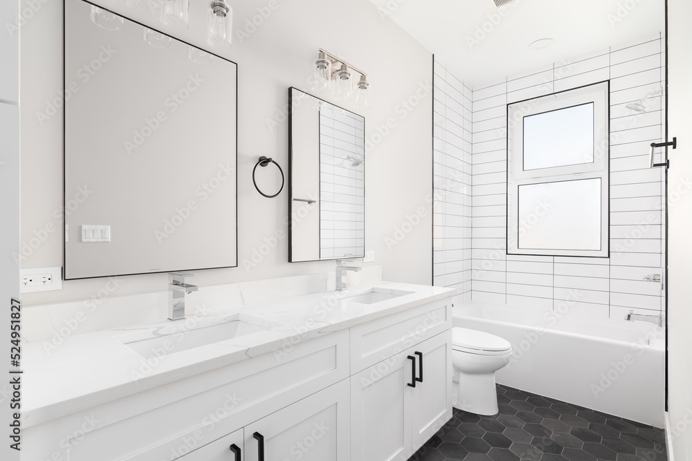 A white luxury bathroom with a white vanity and marble