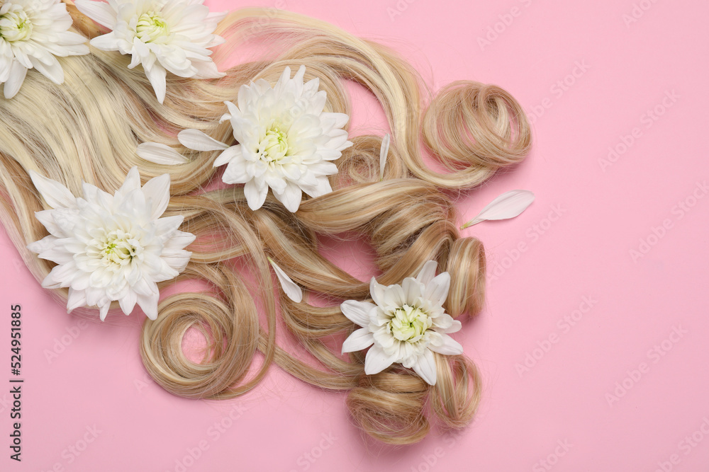 Lock of healthy blond hair with flowers on pink background, flat lay. Space for text