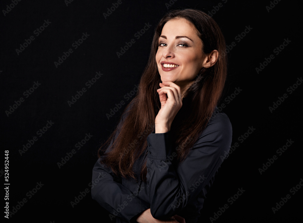 Beautiful thinking toothy smiling business woman with folded arms in blue shirt on black background with empty copy space for text. Closeup Beautiful thinking toothy smiling business woman with folded arms in blue shirt on black background with empty copy space for text. Closeup