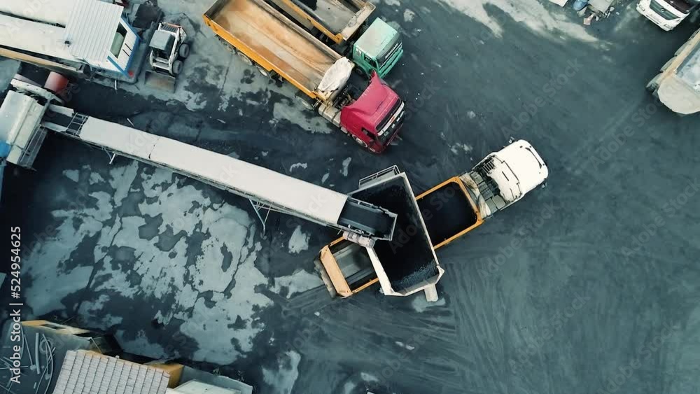Aerial top down view of loading stone on a dump truck in a stone quarry. Aerial top down view of loading stone on a dump truck in a stone quarry.