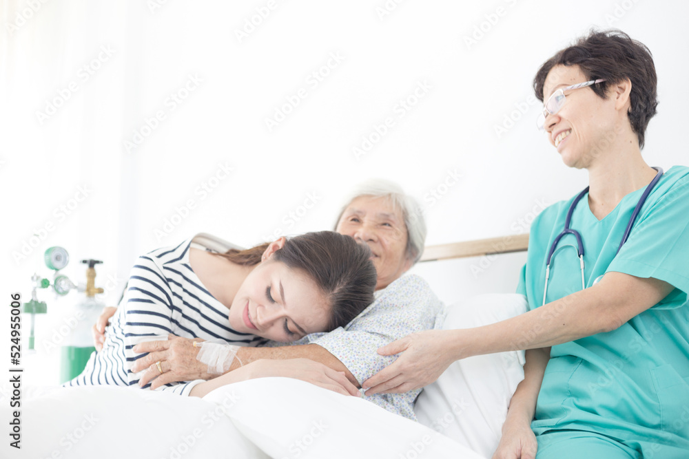 young Asian female hug old female patient, mother's day , family time, palliative care in hospital young Asian female hug old female patient, mother's day , family time, palliative care in hospital