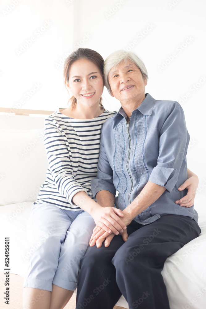young Asian female hug old female, mother's day , family time, hand in hand