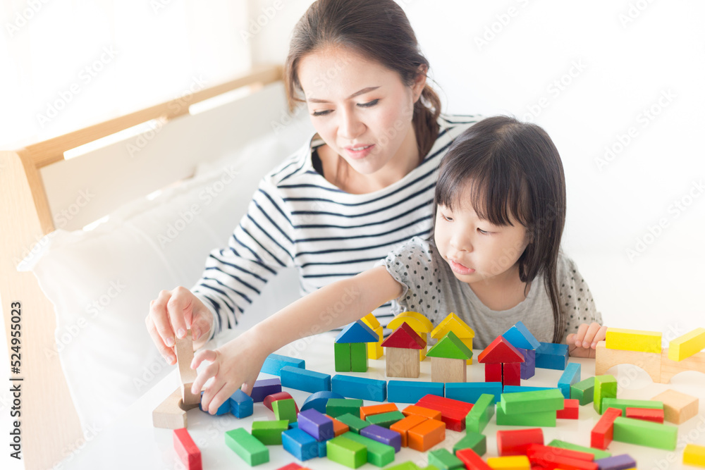 asian baby and her mother play puzzle wood toy, leaning and development asian baby and her mother play puzzle wood toy, leaning and development