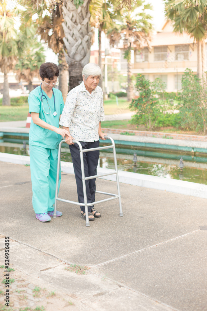 Asian old female train use walker with health worker, stroke patient use walker, walk training, rehabilitation process Asian old female train use walker with health worker, stroke patient use walker, walk training, rehabilitation process