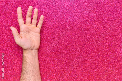 open man hand palm on pink glitter background