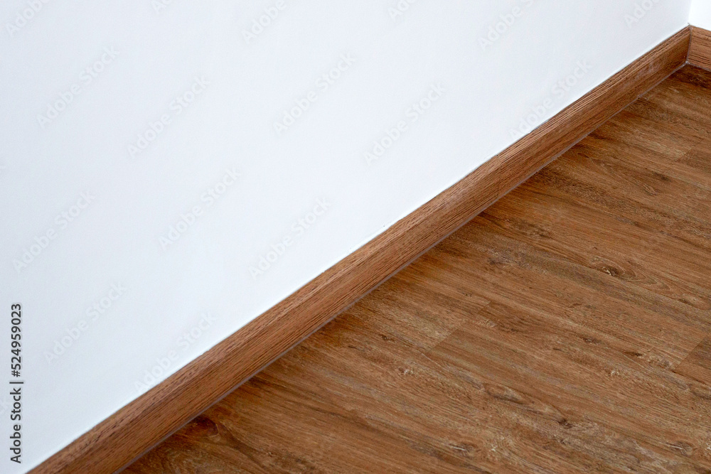 Laminate wood floor with blank white wall Laminate wood floor with blank white wall