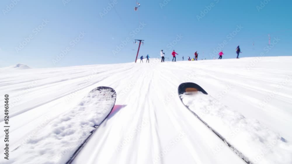 Skiers on a ski lift. Low angle view focus on skis. Skiers on a ski lift. Low angle view focus on skis.