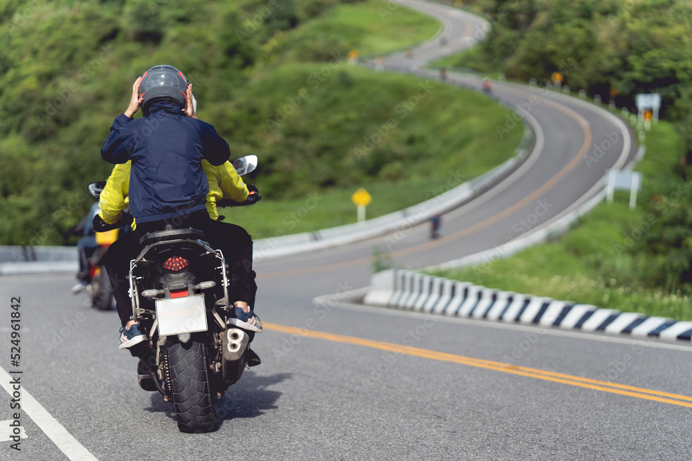 A man and a woman ride together on a sports motorcycle. Motorcyclists travel around the city during the day on a touring bike. A man and a woman ride together on a sports motorcycle. Motorcyclists travel around the city during the day on a touring bike.