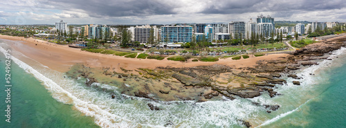 Panoramic aerial view of high rise real estate along a stretch of rocky coastline photo