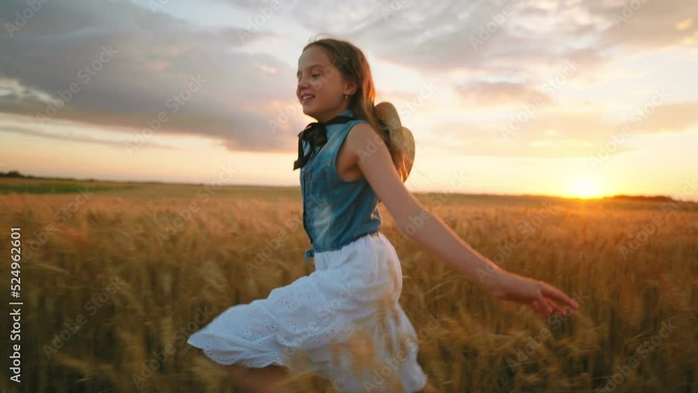charming preteen girl is running on beautiful golden rye field in summer vacation, slow motion shot charming preteen girl is running on beautiful golden rye field in summer vacation, slow motion shot